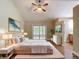 The main bedroom features a king bed, sliding glass doors, ceiling fan, and ensuite bathroom at 3810 Hollister Pl, Brandon, FL 33511
