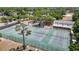 A high aerial shot displays three fenced tennis courts ready for play and competition at 3810 Hollister Pl, Brandon, FL 33511