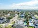 An aerial view shows the neighborhood, streets, and some homes with pools, with the city skyline in the distance at 4104 W Watrous Ave, Tampa, FL 33629