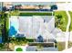 An aerial view reveals a home with a pristine pool, lush landscaping, and a well-maintained roof at 4104 W Watrous Ave, Tampa, FL 33629