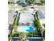 Aerial perspective features a swimming pool, manicured lawn, and neighborhood charm at 4104 W Watrous Ave, Tampa, FL 33629