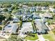 A high-angle view shows several swimming pools surrounded by houses and trees at 4104 W Watrous Ave, Tampa, FL 33629