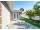 Backyard brick patio and a partial view of the yard and white fencing at 4104 W Watrous Ave, Tampa, FL 33629