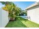 Palm trees and manicured green space in this sunny backyard with white vinyl fencing at 4104 W Watrous Ave, Tampa, FL 33629