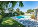Serene backyard pool area surrounded by vibrant greenery and a paved patio, perfect for relaxation at 4104 W Watrous Ave, Tampa, FL 33629