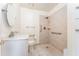 Bright bathroom features a walk-in shower with grab bars, single sink, and toilet at 4104 W Watrous Ave, Tampa, FL 33629