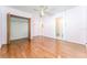 Bright bedroom features hardwood floors, ceiling fan, closet, and an attached bathroom at 4104 W Watrous Ave, Tampa, FL 33629