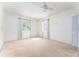 This bedroom features carpeting, two windows with light curtains, and white walls at 4104 W Watrous Ave, Tampa, FL 33629