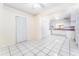 Inviting dining space with white tile floors leads to a kitchen equipped with white appliances at 4104 W Watrous Ave, Tampa, FL 33629