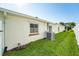 Home exterior with a well maintained lawn and an AC unit at 4104 W Watrous Ave, Tampa, FL 33629