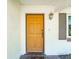 Inviting front entrance featuring a bright door, decorative lantern, and a welcoming 'Home' doormat at 4104 W Watrous Ave, Tampa, FL 33629