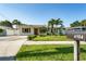 A charming single-story home with a well-manicured lawn and mature palm trees creates an inviting curb appeal at 4104 W Watrous Ave, Tampa, FL 33629