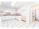 Bright kitchen featuring white cabinets, pink countertops, and a window that offers natural light at 4104 W Watrous Ave, Tampa, FL 33629