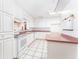 Bright kitchen features white cabinets, pink countertops, and modern appliances at 4104 W Watrous Ave, Tampa, FL 33629