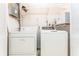 Laundry room features a new washer, dryer, and white painted walls at 4104 W Watrous Ave, Tampa, FL 33629