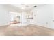 Living room featuring tile and carpet flooring that connects to the kitchen at 4104 W Watrous Ave, Tampa, FL 33629