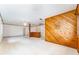Expansive living area with striking wood paneling, bright white brick, and a cozy carpeted space at 4104 W Watrous Ave, Tampa, FL 33629