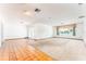 Expansive living room with tile and carpet flooring and a window offering natural light at 4104 W Watrous Ave, Tampa, FL 33629