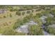 Scenic aerial view of the townhouse complex nestled along a lush golf course with mature trees and tranquil ponds at 4137 Northmeadow Cir, Tampa, FL 33618