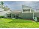 Backyard features vibrant green grass, a modern privacy fence, and partial view of the home at 4137 Northmeadow Cir, Tampa, FL 33618