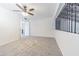 Bright bedroom with carpet, ceiling fan, and an open door to an attached bathroom at 4137 Northmeadow Cir, Tampa, FL 33618