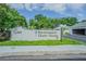Welcoming community sign for Northmeadow Cluster Houses amidst lush landscaping and greenery exudes curb appeal at 4137 Northmeadow Cir, Tampa, FL 33618