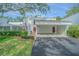 Charming townhouse with a covered carport, well-maintained landscaping, and a welcoming brick pathway at 4137 Northmeadow Cir, Tampa, FL 33618