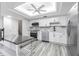 Bright kitchen features stainless steel appliances, white cabinets, and stone countertops at 4137 Northmeadow Cir, Tampa, FL 33618