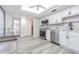 Bright kitchen features stainless appliances, white cabinets, and stairs to second floor at 4137 Northmeadow Cir, Tampa, FL 33618