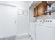 Functional laundry area with appliances, cabinets, shelving, and exterior access door at 4137 Northmeadow Cir, Tampa, FL 33618
