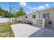 Charming backyard offers pea gravel lounge area and white vinyl fence at 4219 26Th N Ave, St Petersburg, FL 33713