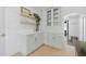Kitchen cabinetry and counters are light-green with white walls, light wood floor at 4219 26Th N Ave, St Petersburg, FL 33713