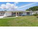 Inviting single-story home featuring a well-maintained lawn, quaint front porch, and attached garage at 4219 26Th N Ave, St Petersburg, FL 33713