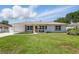 Charming single-story home with a well-maintained lawn, beautiful flower bed, and inviting curb appeal at 4219 26Th N Ave, St Petersburg, FL 33713