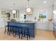 Stylish kitchen featuring a large center island with seating, modern lighting, and stainless steel appliances at 4219 26Th N Ave, St Petersburg, FL 33713