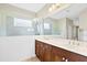 Bright bathroom featuring a double vanity with a glass-enclosed shower at 4410 Natures Reach Ter, Parrish, FL 34219