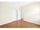 Bedroom featuring hardwood floors, neutral walls, white trim, and closet at 4410 Natures Reach Ter, Parrish, FL 34219