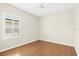 Bright bedroom featuring hardwood floors and a shuttered window for natural light at 4410 Natures Reach Ter, Parrish, FL 34219