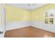 Bedroom with hardwood floors, chair railing, ceiling fan, and shuttered window at 4410 Natures Reach Ter, Parrish, FL 34219