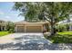 A beautiful, single-story home with a three-car garage and mature landscaping at 4410 Natures Reach Ter, Parrish, FL 34219