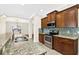 Modern kitchen with stainless steel appliances, granite countertops, and beautiful backsplash at 4410 Natures Reach Ter, Parrish, FL 34219