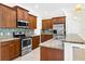 Well-appointed kitchen featuring stainless steel appliances, granite countertops, and a breakfast bar at 4410 Natures Reach Ter, Parrish, FL 34219