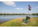 Beautiful lake view with a bench to enjoy the scenery near an American flag at 4410 Natures Reach Ter, Parrish, FL 34219