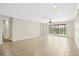 Spacious living room with tile floors and sliding glass doors leading to the backyard at 4410 Natures Reach Ter, Parrish, FL 34219