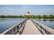 Scenic pier extending over the water with gazebo and beautiful views on a sunny day at 4410 Natures Reach Ter, Parrish, FL 34219