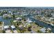 Waterfront home featuring a boat lift and dock, surrounded by lush landscaping and stunning water views at 4451 San Juan Dr, Hernando Beach, FL 34607
