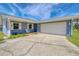 Charming single-story home with an attached garage and large driveway at 4451 San Juan Dr, Hernando Beach, FL 34607