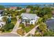 Lovely aerial view of a meticulously landscaped home with a gray roof near bay waters at 4935 W Bay Way Pl, Tampa, FL 33629