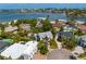 Waterfront property showcasing lush landscape, circular driveway, and stylish architecture at 4935 W Bay Way Pl, Tampa, FL 33629