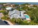 Back aerial view of the house showcasing a pool, covered patio and well-manicured lawn at 4935 W Bay Way Pl, Tampa, FL 33629